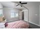 Bright bedroom featuring a bed, a ceiling fan, and a bright window at 12495 Point Sierra St, Las Vegas, NV 89138