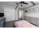 Cozy bedroom with a bed frame, ceiling fan, desk, and ample closet space at 12495 Point Sierra St, Las Vegas, NV 89138