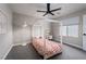 Well-lit bedroom featuring a bed, a ceiling fan, and a bright window at 12495 Point Sierra St, Las Vegas, NV 89138