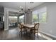Cozy dining room with modern chandelier, wood-look floors, and backyard patio access at 12495 Point Sierra St, Las Vegas, NV 89138