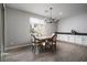 Bright dining area with built in cabinets and counter, wood-look flooring, and modern chandelier at 12495 Point Sierra St, Las Vegas, NV 89138
