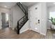 Stylish entryway with wood flooring, a modern staircase, and a white front door at 12495 Point Sierra St, Las Vegas, NV 89138