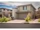 This is a modern two-story home featuring a two-car garage and desert landscaping at 12495 Point Sierra St, Las Vegas, NV 89138