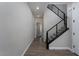 Hallway with wood-look tile floors and modern staircase with metal railings at 12495 Point Sierra St, Las Vegas, NV 89138