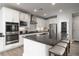 Bright kitchen with white cabinets, stainless steel appliances, and large center island with seating at 12495 Point Sierra St, Las Vegas, NV 89138