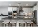 Kitchen island with quartz countertops, seating for four, and stainless steel appliances at 12495 Point Sierra St, Las Vegas, NV 89138