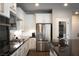Modern kitchen featuring stainless steel appliances, white cabinets, and eat-in island at 12495 Point Sierra St, Las Vegas, NV 89138