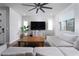 Inviting living room with a comfortable couch, entertainment center, and natural light from windows at 12495 Point Sierra St, Las Vegas, NV 89138