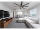 Loft area with an entertainment center, ceiling fan, and comfortable couch at 12495 Point Sierra St, Las Vegas, NV 89138