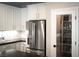 Kitchen features a stainless refrigerator, white cabinets, and adjacent pantry at 12495 Point Sierra St, Las Vegas, NV 89138