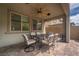 Covered patio with an outdoor dining table and ceiling fan at 12495 Point Sierra St, Las Vegas, NV 89138