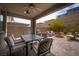 Covered patio with an outdoor dining table and a view of the landscaped backyard at 12495 Point Sierra St, Las Vegas, NV 89138