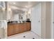 Elegant bathroom featuring double sinks, granite counters, and a large, well-lit mirror at 125 E Harmon Ave # 2215, Las Vegas, NV 89109