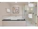 Bright bathroom features a luxurious soaking tub, glass enclosed shower and neutral toned tile at 125 E Harmon Ave # 2215, Las Vegas, NV 89109