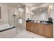 Luxurious bathroom featuring a glass shower, soaking tub, and dual sink vanity at 125 E Harmon Ave # 2215, Las Vegas, NV 89109
