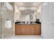Modern bathroom featuring a double vanity, framed mirror, and glass-enclosed shower at 125 E Harmon Ave # 2215, Las Vegas, NV 89109