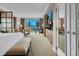 Bright bedroom with neutral colors, king bed, city views, and a convenient bar area at 125 E Harmon Ave # 2215, Las Vegas, NV 89109