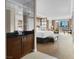Bright bedroom with neutral colors, king bed, city views, and a convenient bar area at 125 E Harmon Ave # 2215, Las Vegas, NV 89109