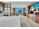 Bright bedroom with neutral colors, king bed, city views, and a convenient bar area at 125 E Harmon Ave # 2215, Las Vegas, NV 89109