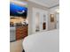 Comfortable bedroom features a large TV, granite counters, and a mirrored closet door at 125 E Harmon Ave # 2215, Las Vegas, NV 89109