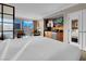 Bright bedroom with neutral colors, king bed, city views, and a convenient bar area at 125 E Harmon Ave # 2215, Las Vegas, NV 89109