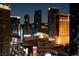 Nighttime cityscape featuring illuminated buildings, streets, and hotels, including The Cosmopolitan at 125 E Harmon Ave # 2215, Las Vegas, NV 89109