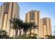 Luxury high-rise buildings showcasing modern architecture and lush palm trees, offering a premium residential experience at 125 E Harmon Ave # 2215, Las Vegas, NV 89109