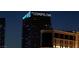Nighttime view of The Cosmopolitan hotel tower with illuminated signage and neighboring buildings at 125 E Harmon Ave # 2215, Las Vegas, NV 89109