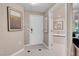 Hallway leading to bathroom showcasing a modern aesthetic with white tile floors at 125 E Harmon Ave # 2215, Las Vegas, NV 89109