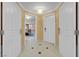 View of tiled hallway with multiple doors and an opening to the suite's seating area at 125 E Harmon Ave # 2215, Las Vegas, NV 89109