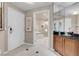 Hallway with bathroom view showcasing sleek tile flooring and modern design elements at 125 E Harmon Ave # 2215, Las Vegas, NV 89109