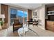 Comfortable living room features an entertainment area, dining table, and city views at 125 E Harmon Ave # 2215, Las Vegas, NV 89109