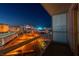 Enjoy the bright city lights from this condo balcony overlooking buildings and the city skyline at night at 125 E Harmon Ave # 2215, Las Vegas, NV 89109