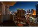 Enjoy the bright city lights from this condo balcony overlooking buildings and the city skyline at night at 125 E Harmon Ave # 2215, Las Vegas, NV 89109