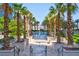 Resort-style pool area with tropical palm trees and inviting lounge area at 125 E Harmon Ave # 2215, Las Vegas, NV 89109