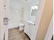 Bathroom featuring a tiled shower, white vanity, and contemporary lighting at 1450 Hialeah Dr # D, Las Vegas, NV 89119