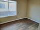 Cozy bedroom featuring wood-look flooring, window and neutral wall color at 1450 Hialeah Dr # D, Las Vegas, NV 89119