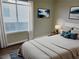 Cozy bedroom with large window, neutral decor, and comfortable furnishings at 1450 Hialeah Dr # D, Las Vegas, NV 89119