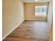 Light-filled bedroom with wood-look flooring and large bright window at 1450 Hialeah Dr # D, Las Vegas, NV 89119