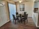 Dining area boasts wood floors, a modern table set, and natural light at 1450 Hialeah Dr # D, Las Vegas, NV 89119