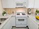 Kitchen features white cabinets, and updated appliances and countertops at 1450 Hialeah Dr # D, Las Vegas, NV 89119