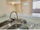 Kitchen sink with granite countertop views the entry and living area at 1450 Hialeah Dr # D, Las Vegas, NV 89119