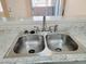 Stainless steel kitchen sink features granite countertop, and modern fixtures at 1450 Hialeah Dr # D, Las Vegas, NV 89119