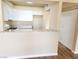 Modern kitchen offers granite countertops, white cabinetry, and laminate floors at 1450 Hialeah Dr # D, Las Vegas, NV 89119