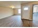 Open living room boasts wood-look floors, a ceiling fan, and a bright entry at 1450 Hialeah Dr # D, Las Vegas, NV 89119