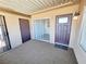 Private covered patio with tile floor, exterior lighting, front door, and sliding glass door at 1450 Hialeah Dr # D, Las Vegas, NV 89119