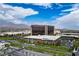 Aerial view of commercial building with views of parking structures, trees, and distant mountains at 205 Derwent Pl, Las Vegas, NV 89144