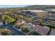 Real estate aerial view shows a neighborhood with mature trees and access to commercial buildings and roads at 205 Derwent Pl, Las Vegas, NV 89144