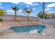 Inviting backyard pool features rock accents and mature palm trees for a tropical feel at 205 Derwent Pl, Las Vegas, NV 89144