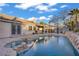 Sparkling pool and spa surrounded by lush landscaping, creating a private oasis in the backyard at 205 Derwent Pl, Las Vegas, NV 89144